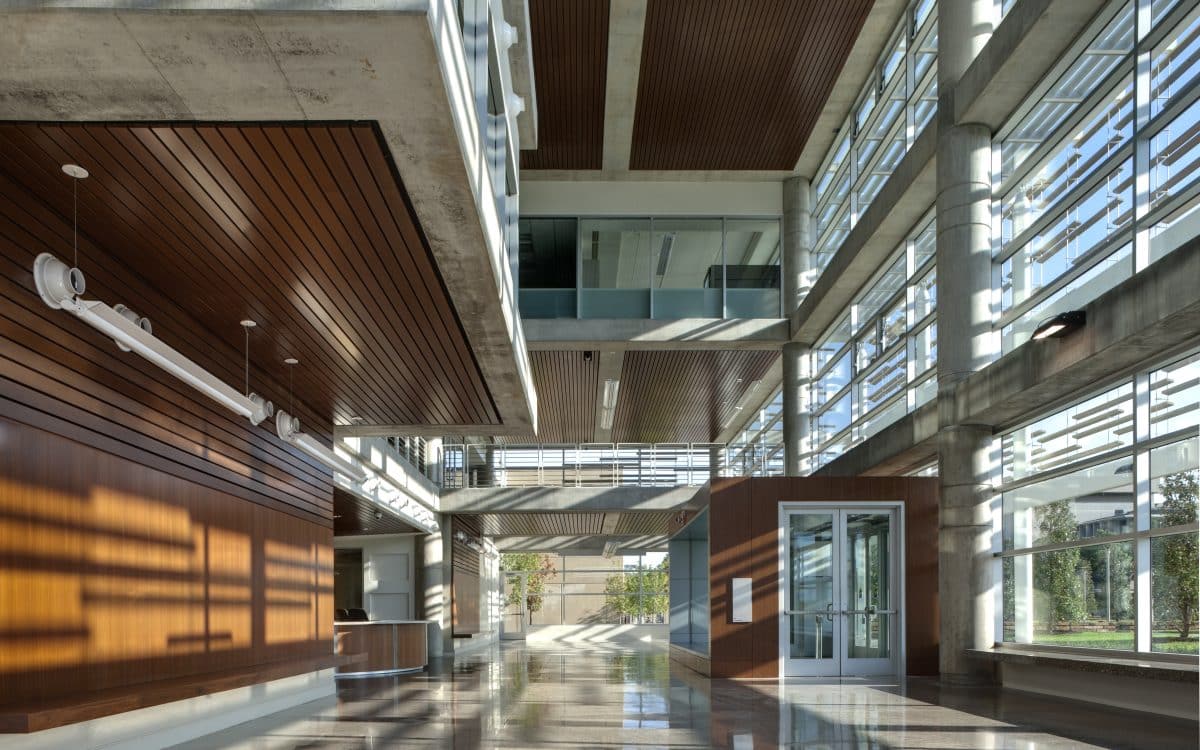 The lobby of a modern building with wood and glass walls.