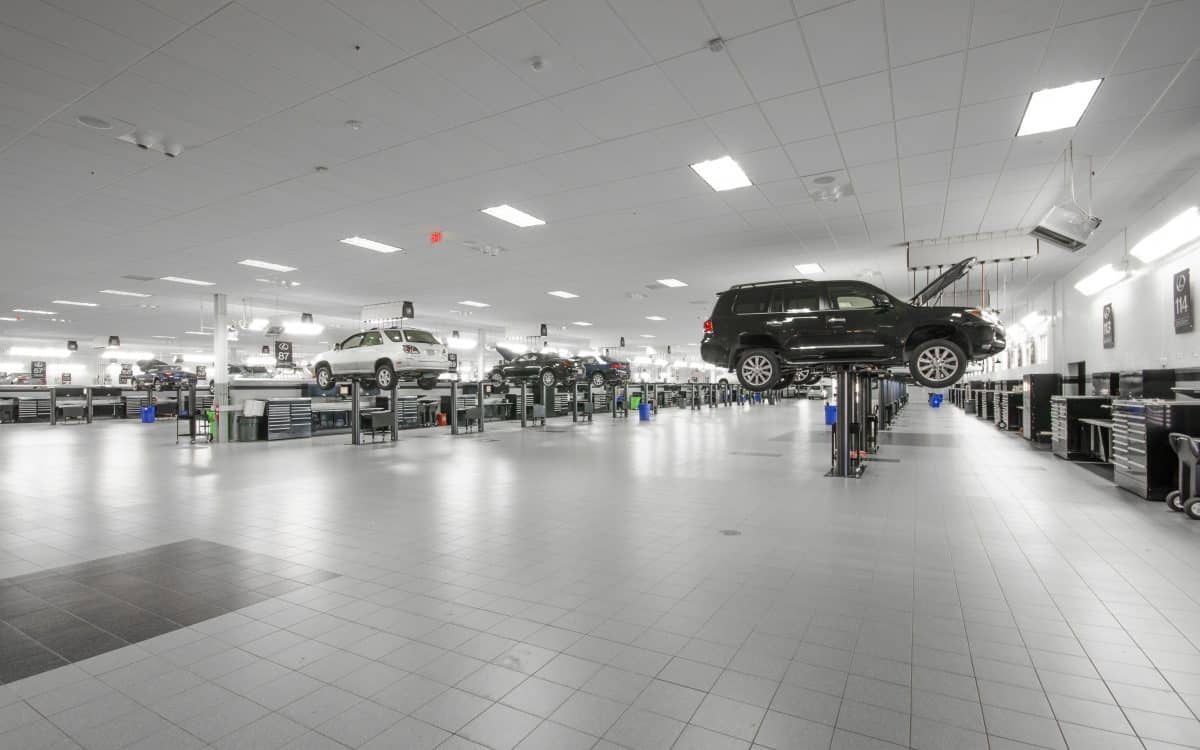 The interior of a car dealership with a lot of vehicles.