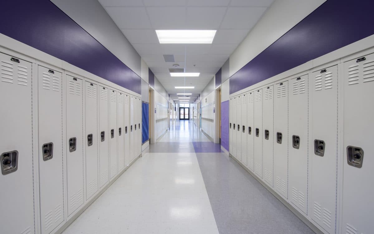 A hallway with white lockers.