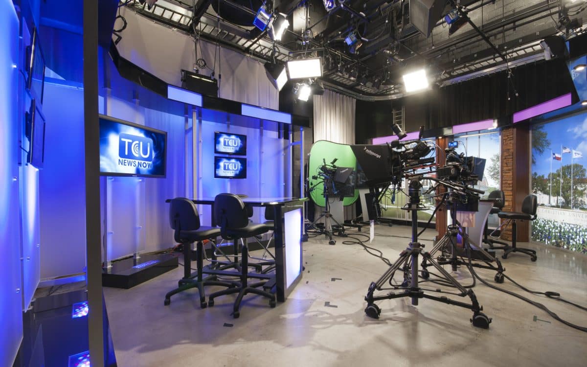 A television studio with a blue screen and a camera.