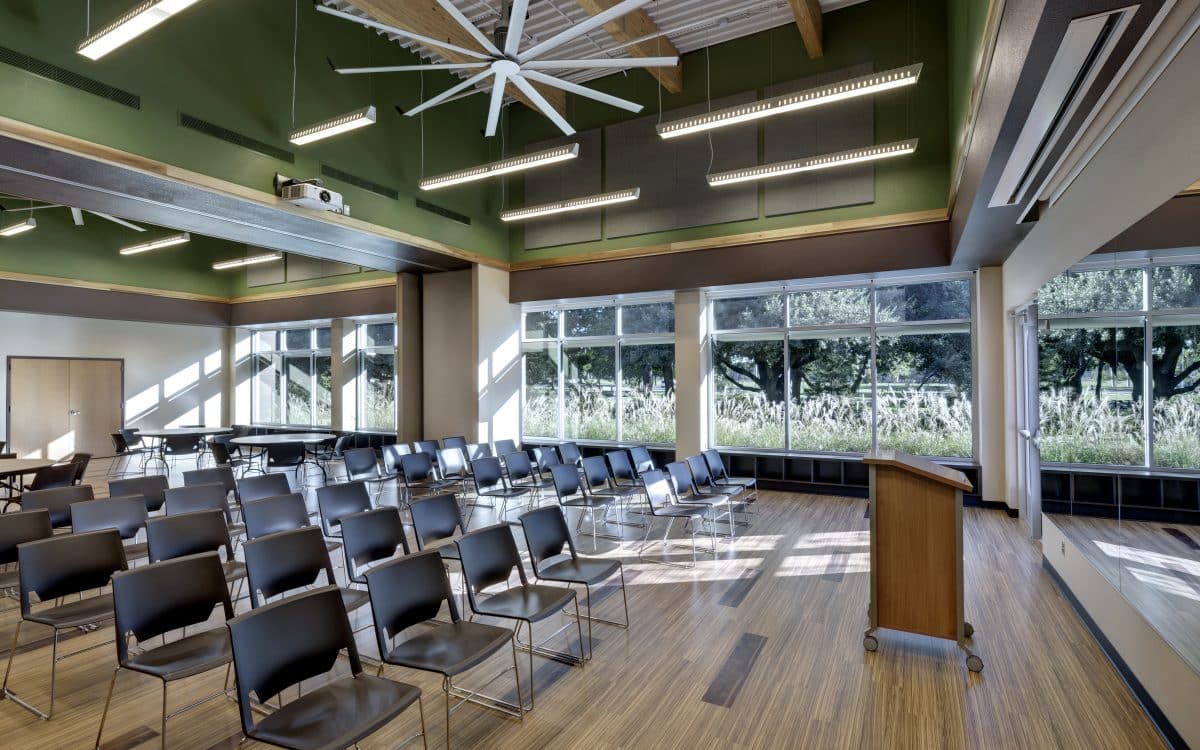 A conference room with chairs and a ceiling fan.