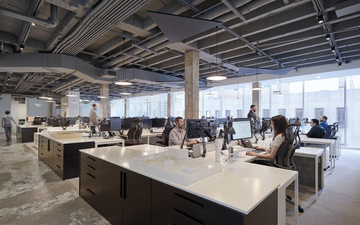A large open office with people working at desks.