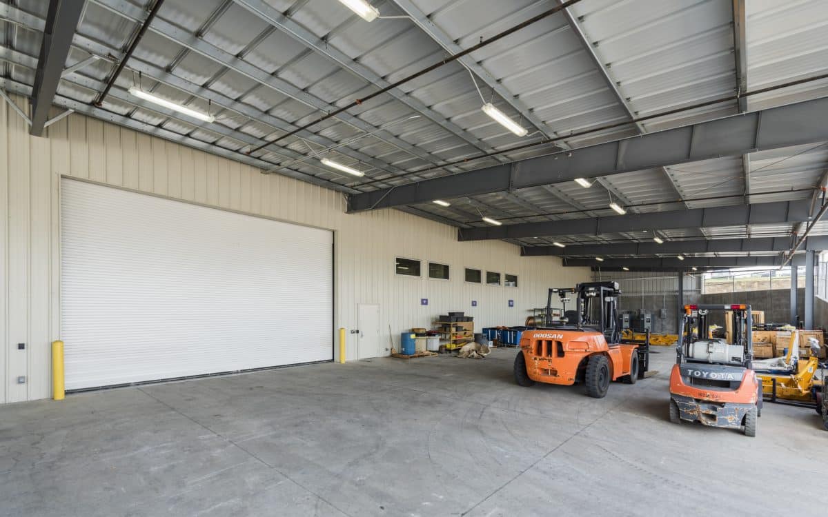 A warehouse with a forklift and a fork truck.