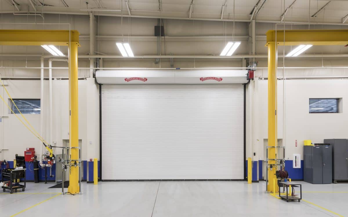 A large warehouse with a large overhead door.