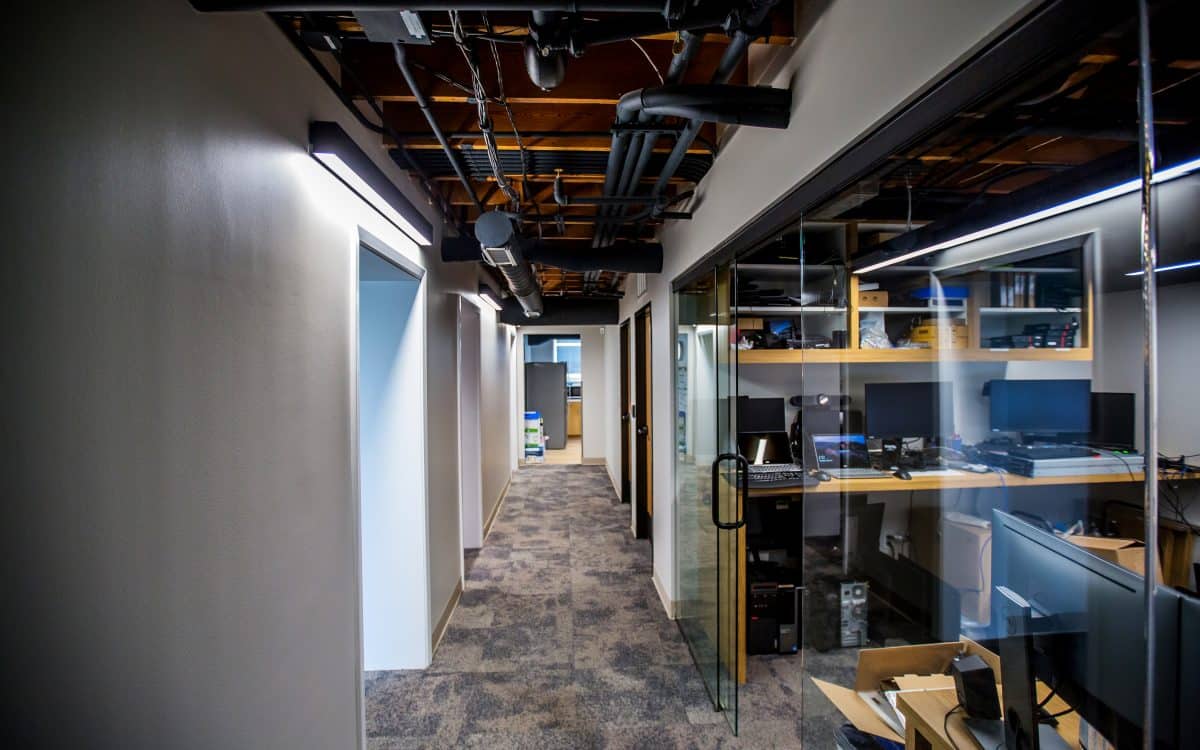 A hallway in an office with a glass wall was part of the municipal construction project.