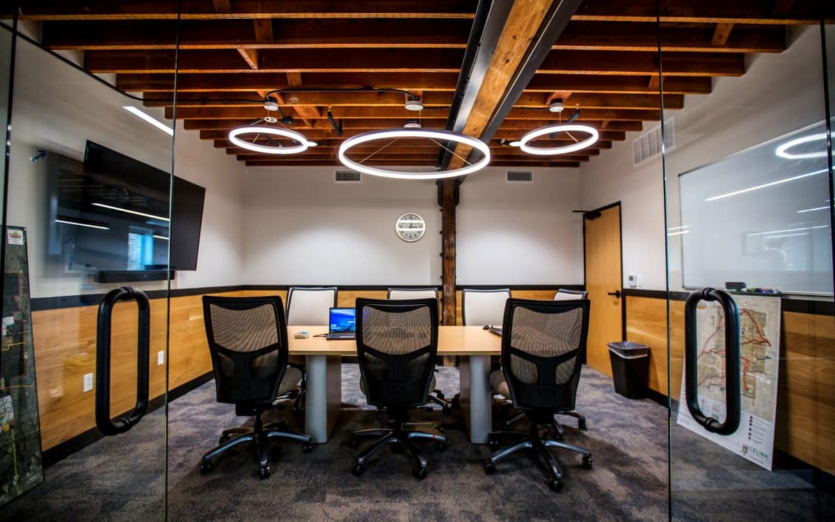A conference room with a wooden table and chairs is ideal for municipal construction meetings.