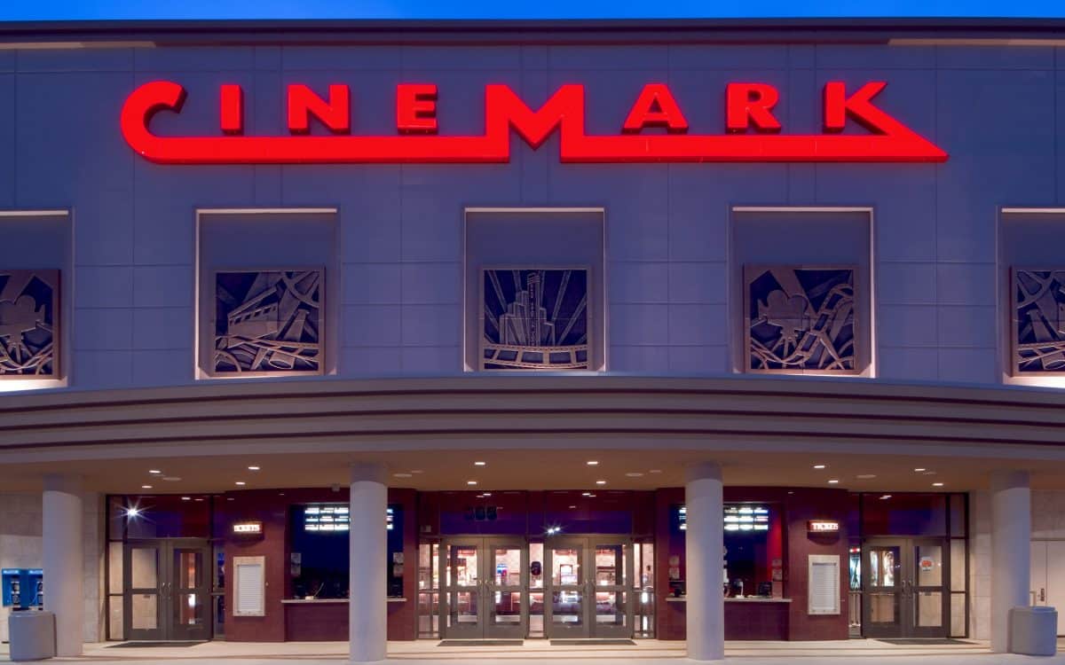 The entrance to a cinemamark theater at dusk.