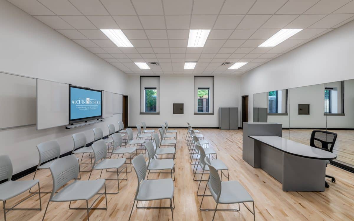 A conference room with chairs and a tv.