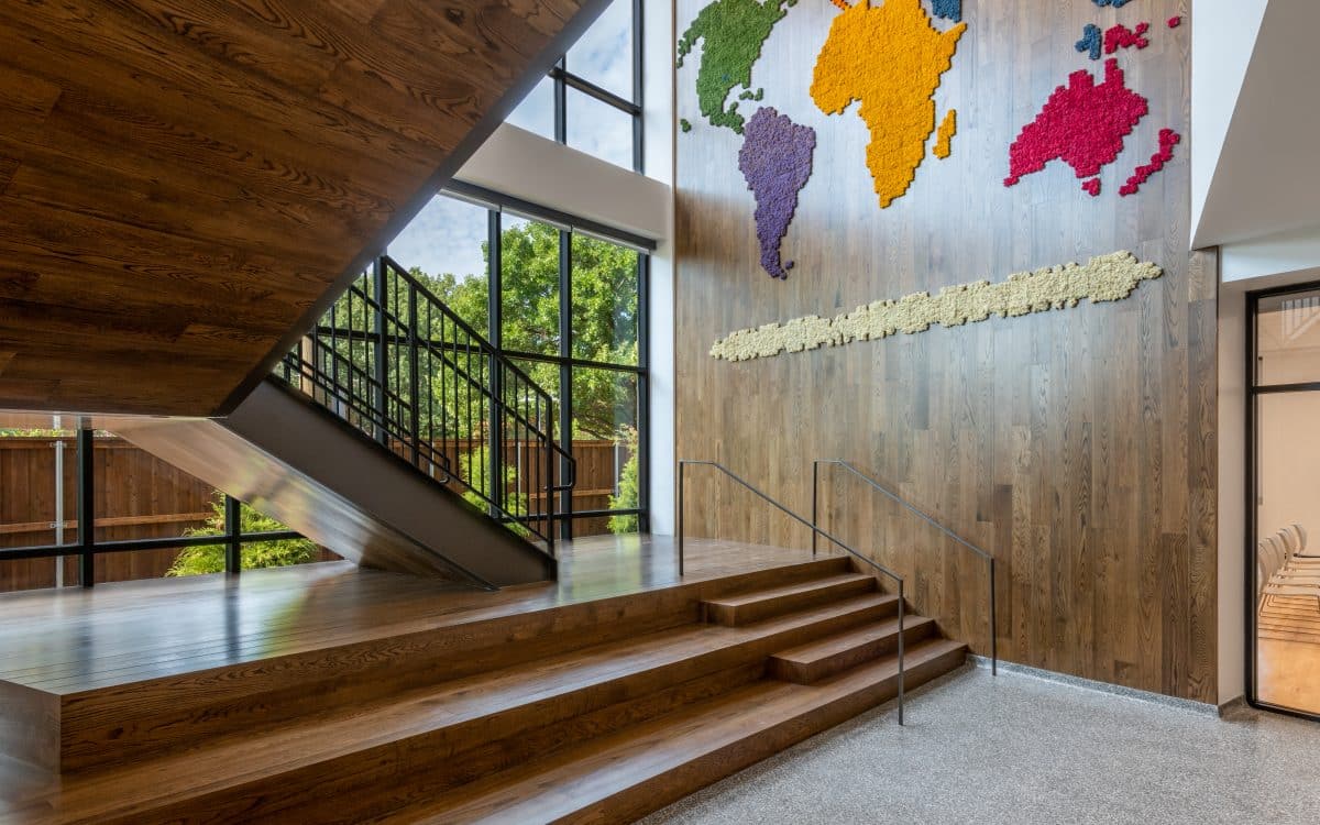 The lobby of a building with a world map on the wall.