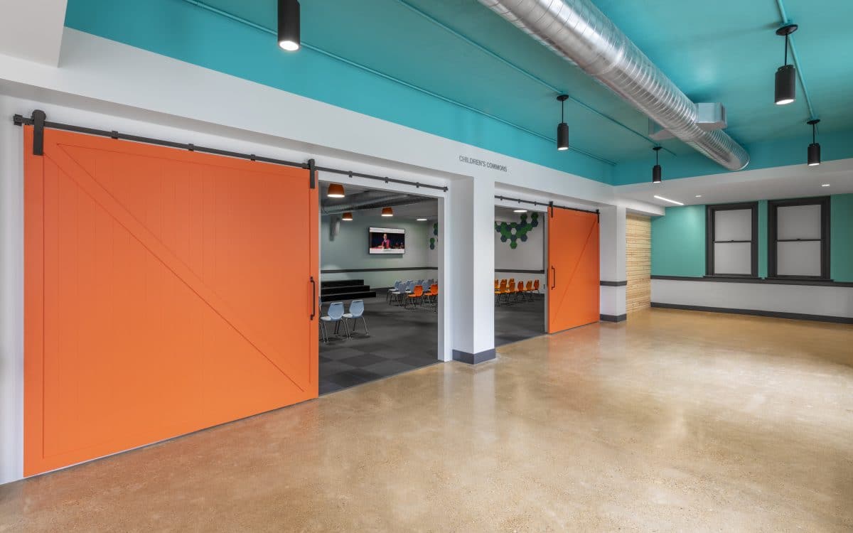 An orange and blue office with a sliding door.
