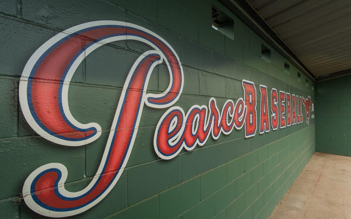 A wall in a dugout with a sign that says peace baseball.