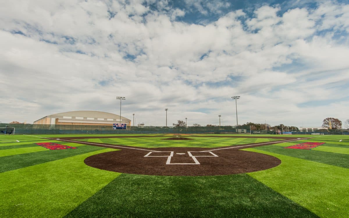 A baseball field with a cloudy sky.
