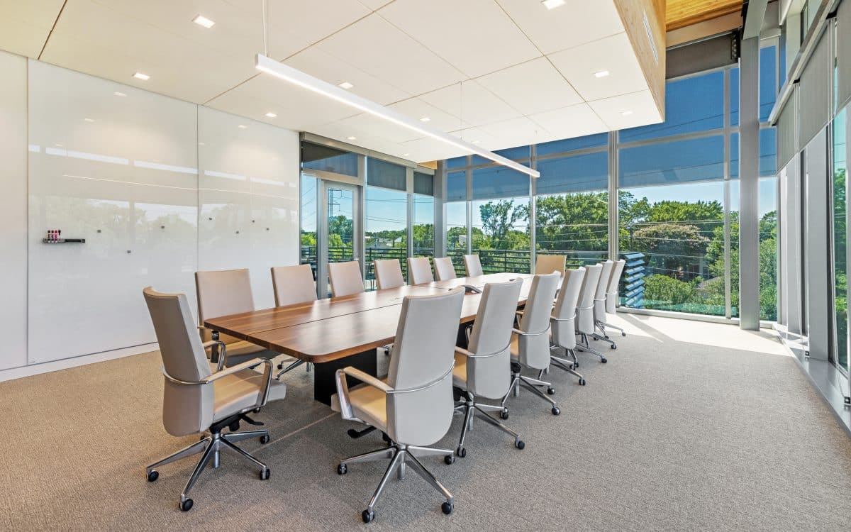 A conference room with glass walls and chairs.