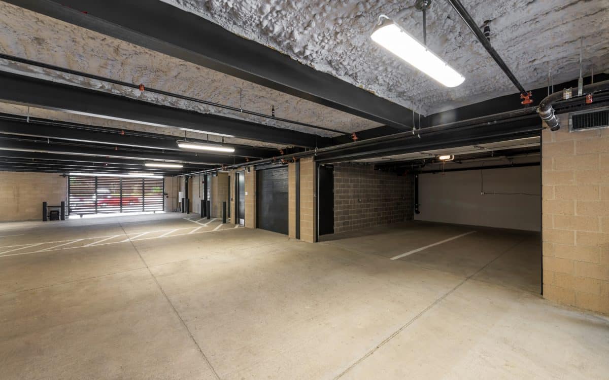 An empty parking garage with a concrete floor.