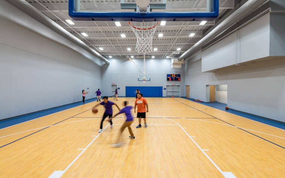 A group of people playing basketball in a gym.