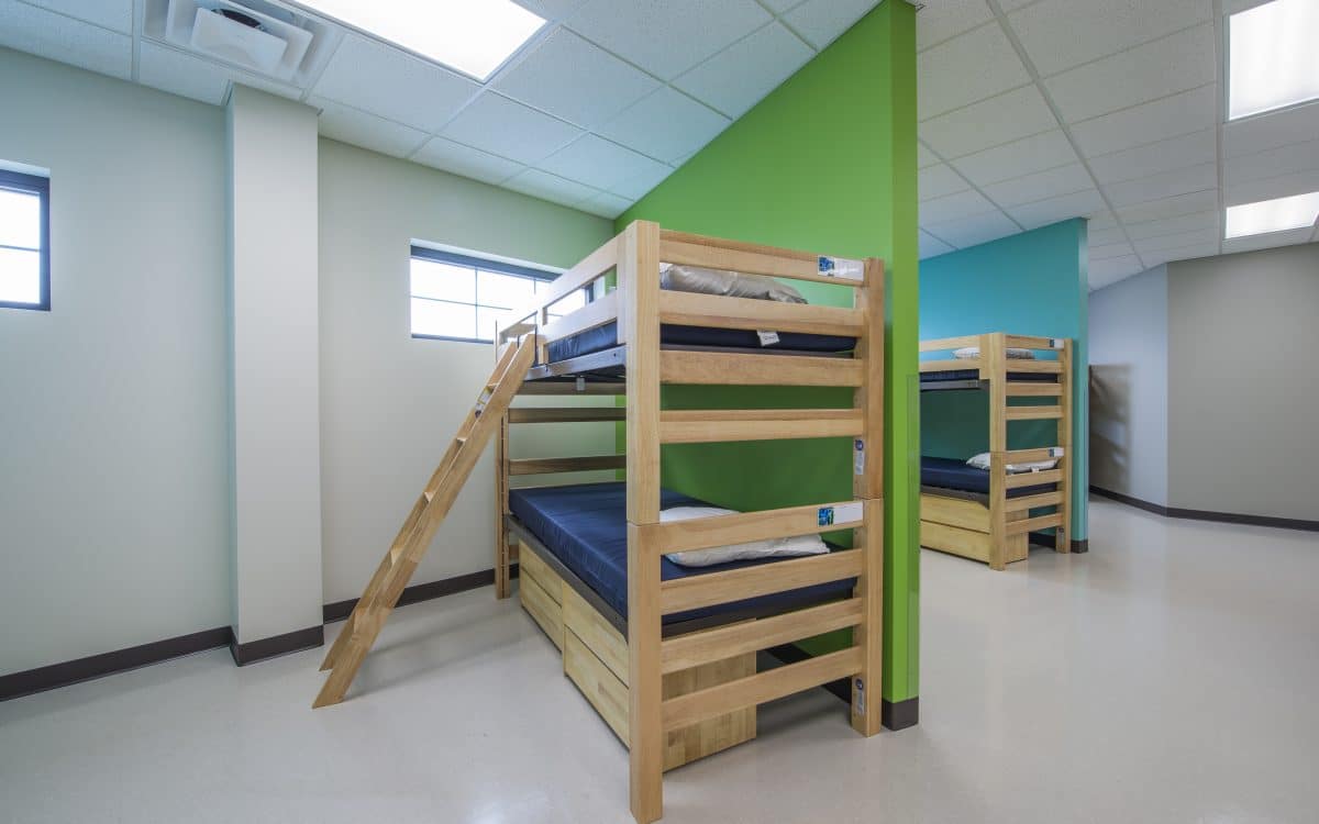 Bunk beds in a room with green walls.