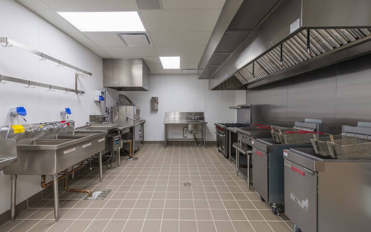 A commercial kitchen with stainless steel appliances.