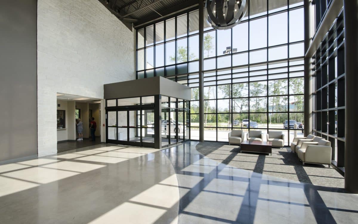 The lobby of an office building with large windows.