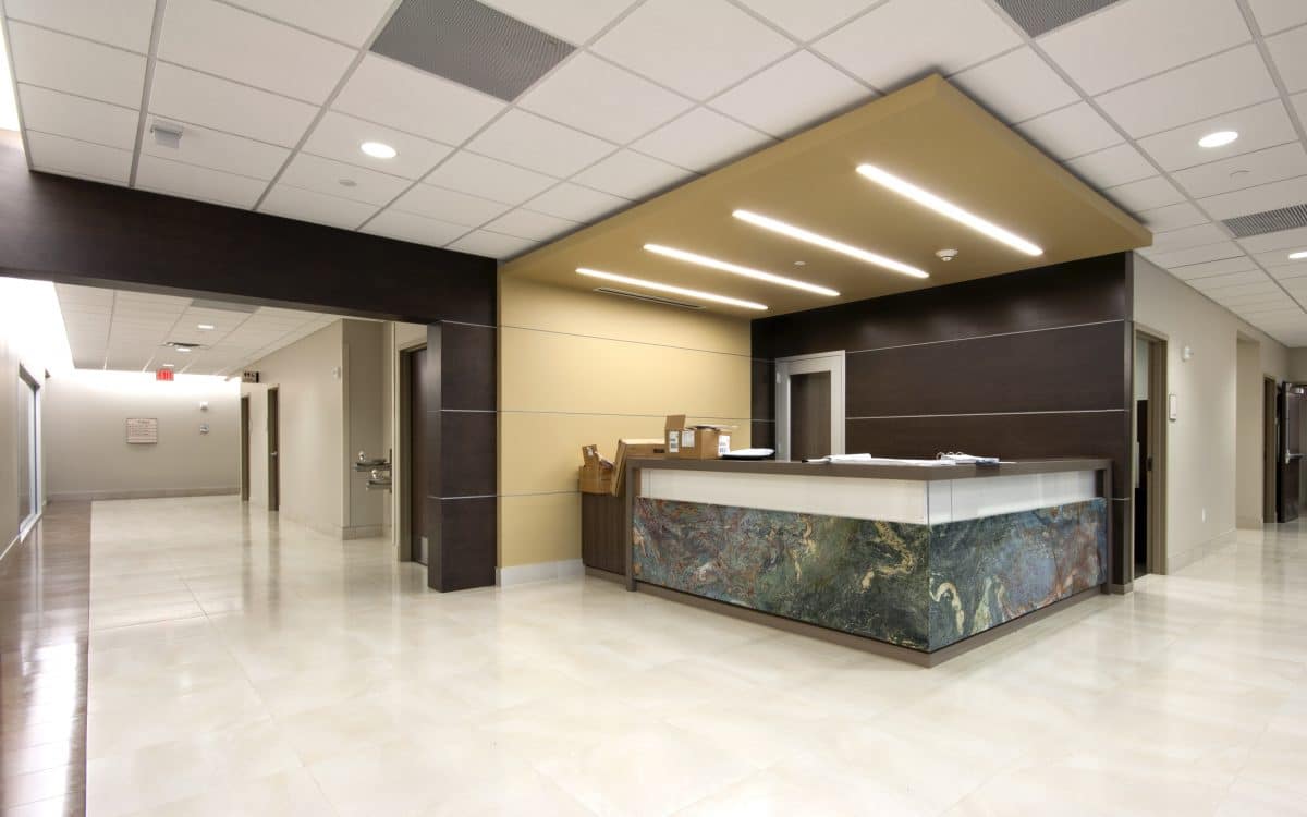 A reception area in a medical office with a marble counter.