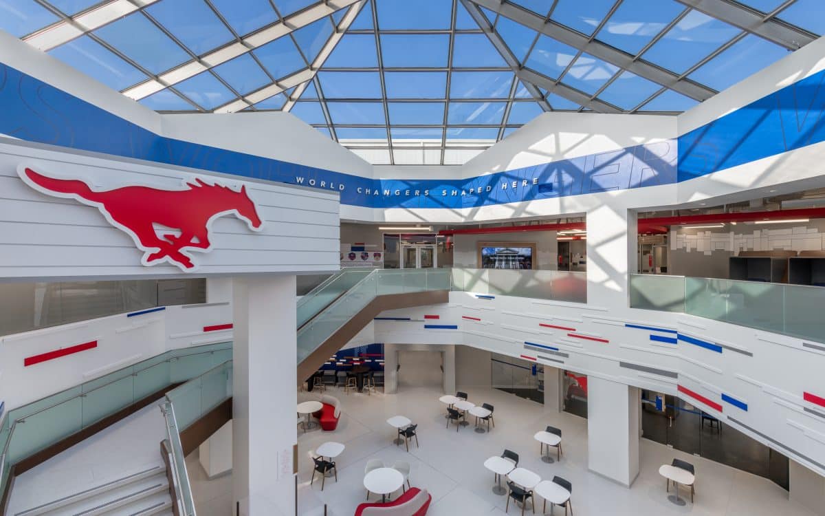 The atrium of a building with a red, white and blue logo.