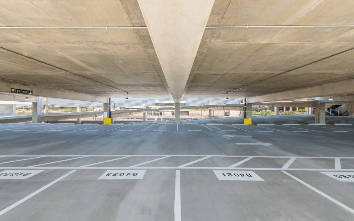 A parking garage with a white line on the floor.